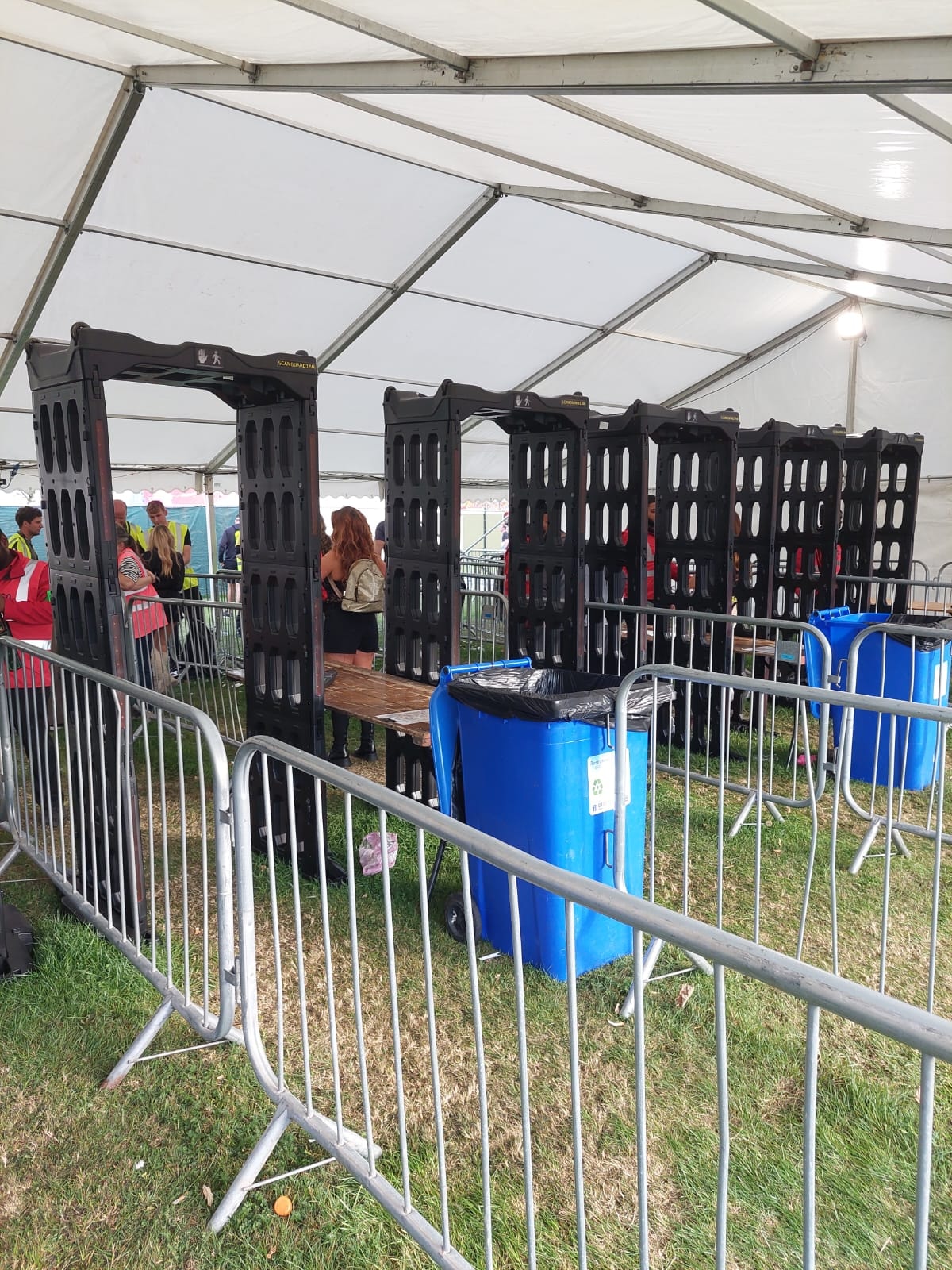 Row of ScanGuardian arches under a festival tent with security staff and crowd barriers